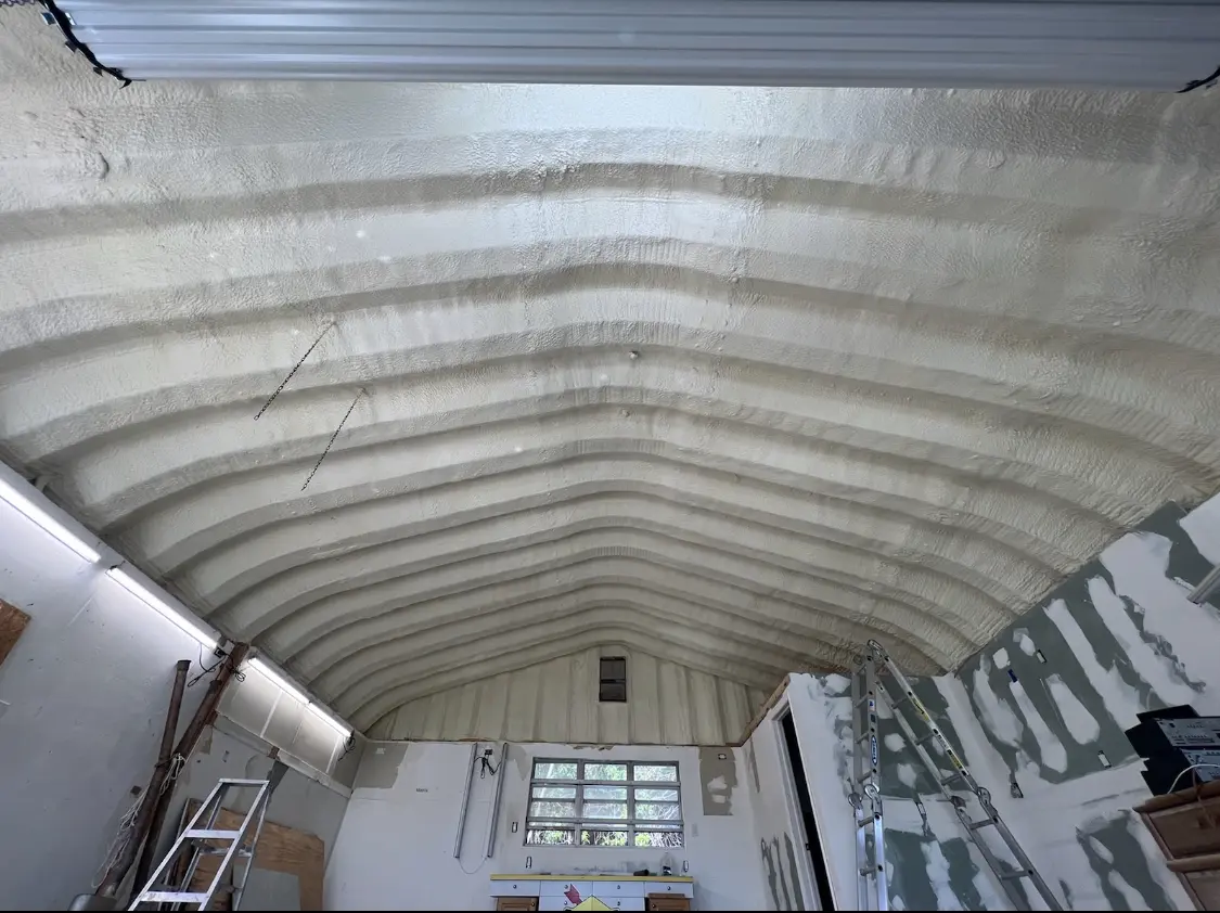 Spray polyurethane foam applied to the underside of a metal roof deck in D'Iberville